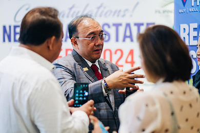 A coach talking with agents on the event floor