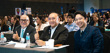 Coaches seated at the front of a packed workshop